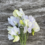 Load image into Gallery viewer, Bouquet of white and light purple flowers on a wooden surface
